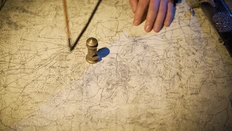 Working-on-a-map-drawn-in-the-Middle-Ages.
